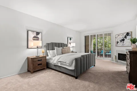 a spacious bedroom with a bed and a couch