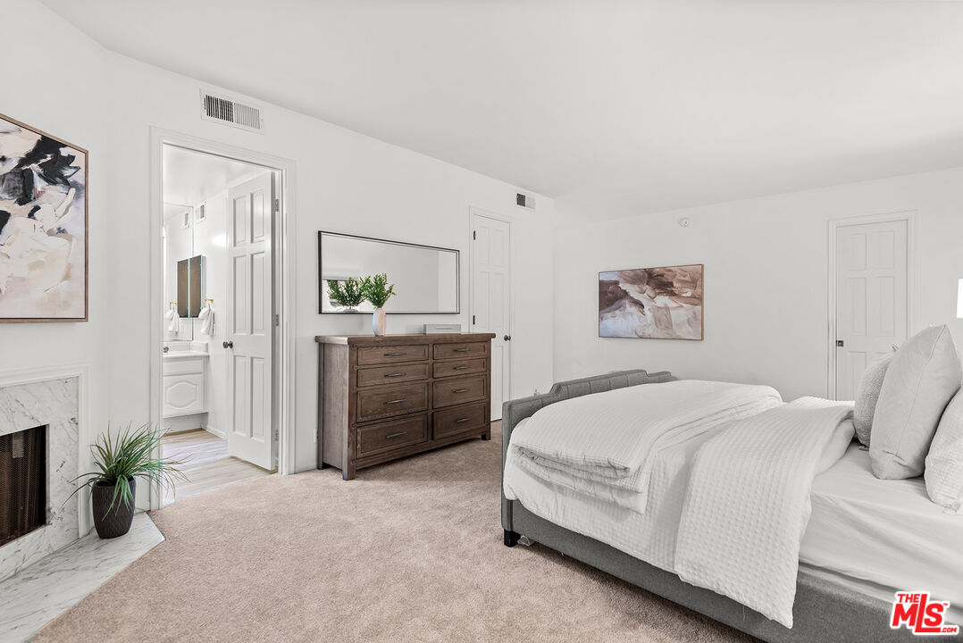 4736 Park Encino Lane, Unit 215 Encino, CA 91436 - Photo 19 of 37 a spacious bedroom with a bed and a couch