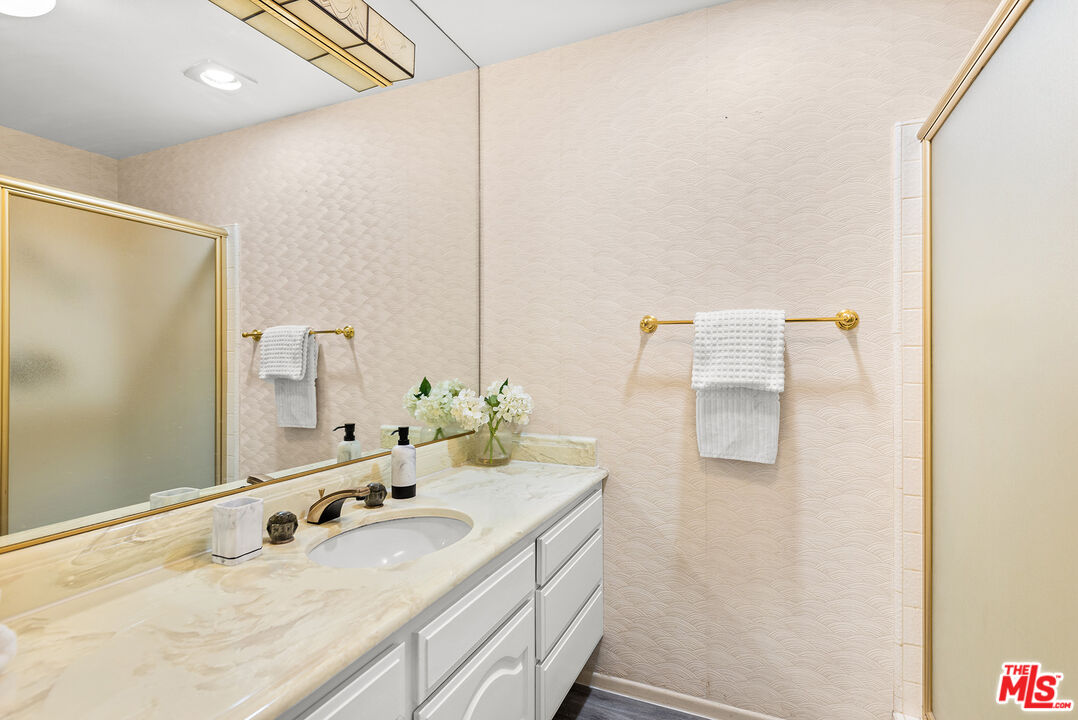4736 Park Encino Lane, Unit 215 Encino, CA 91436 - Photo 24 of 37 a bathroom with a sink double vanity and mirror
