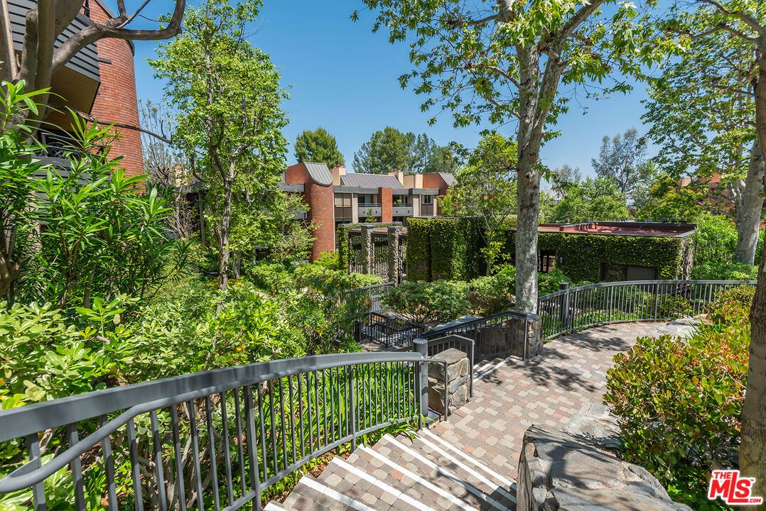 4736 Park Encino Lane, Unit 215 Encino, CA 91436 - Photo 26 of 37 a view of a chair and tables in the garden