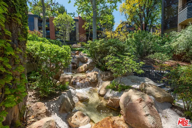 a view of balcony with chairs and umbrella