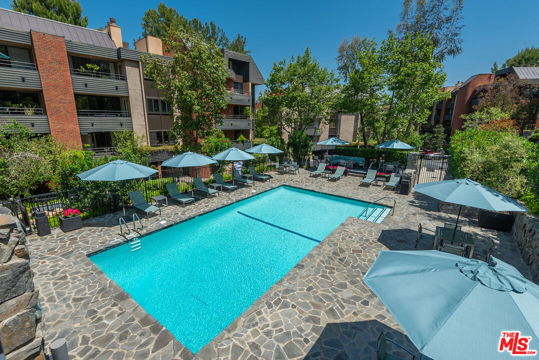 4736 Park Encino Lane, Unit 215 Encino, CA 91436 - Photo 33 of 37 an outdoor space with pool and furniture