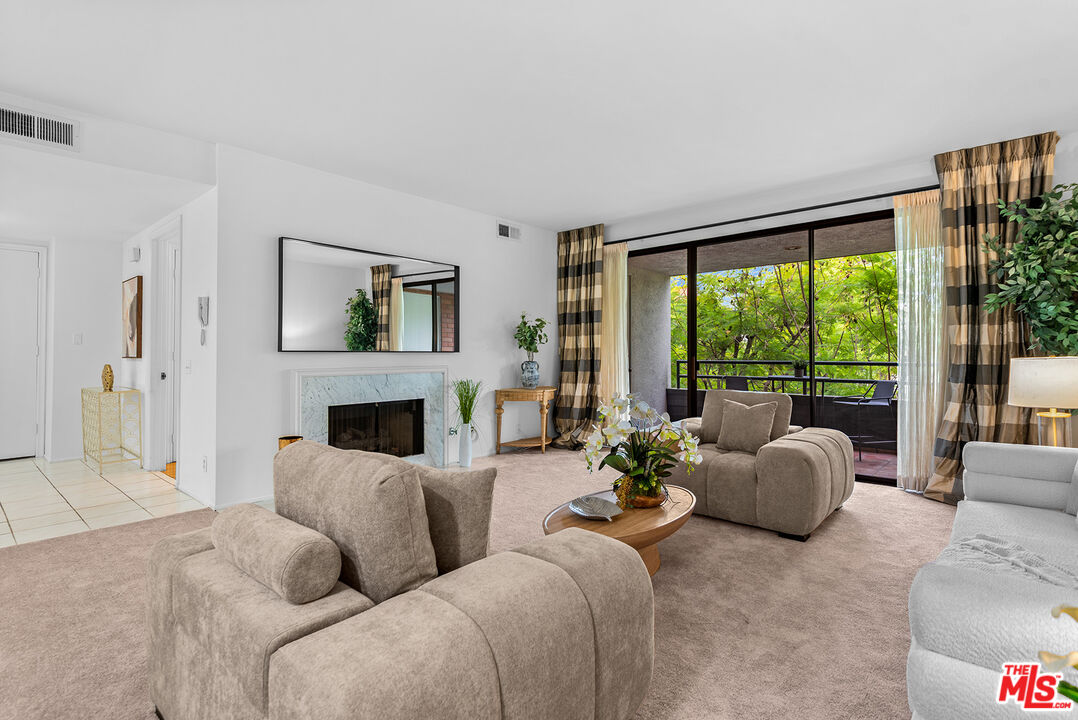 4736 Park Encino Lane, Unit 215 Encino, CA 91436 - Photo 8 of 37 a living room with furniture large window and a fireplace