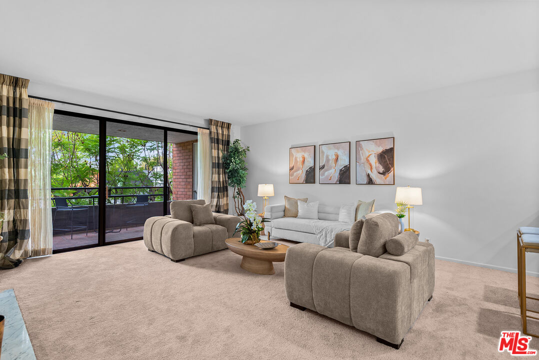 4736 Park Encino Lane, Unit 215 Encino, CA 91436 - Photo 9 of 37 a living room with furniture and a large window