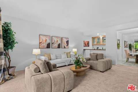 a living room with furniture and flowers