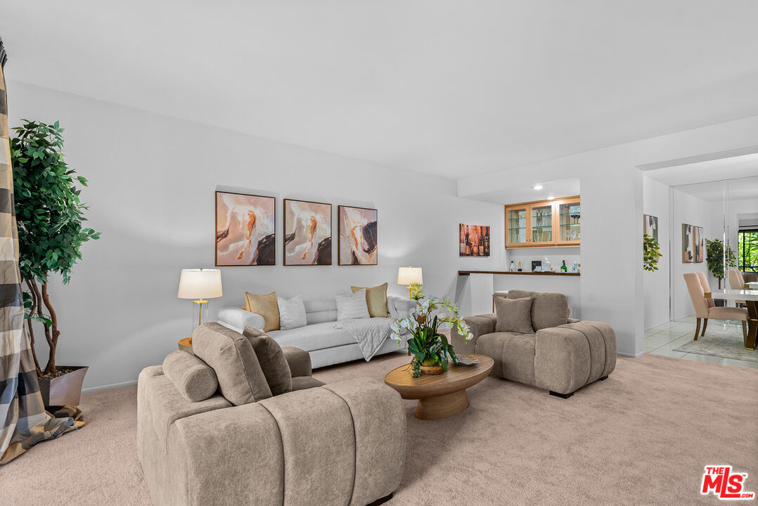 4736 Park Encino Lane, Unit 215 Encino, CA 91436 - Photo 10 of 37 a living room with furniture and flowers