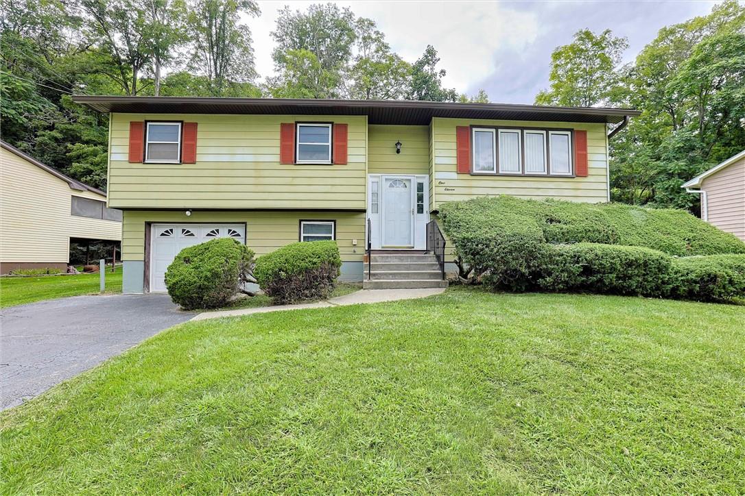 111 Sutton Park Road Poughkeepsie, NY 12603 - Photo 1 of 1 a front view of a house with a yard and garage