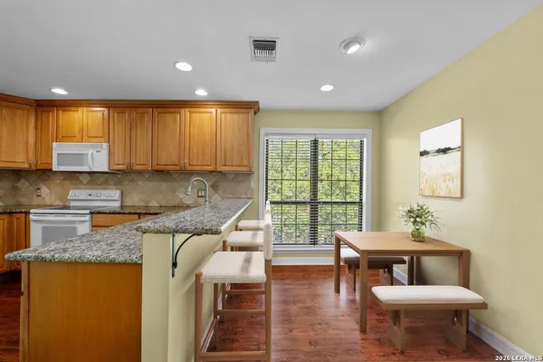 a kitchen with a refrigerator and a sink