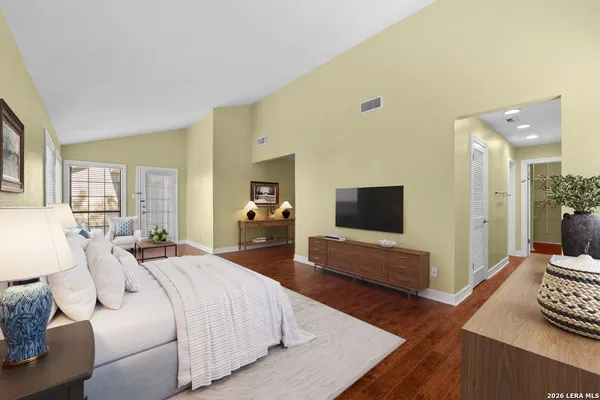 a bedroom with a bed and wooden floor