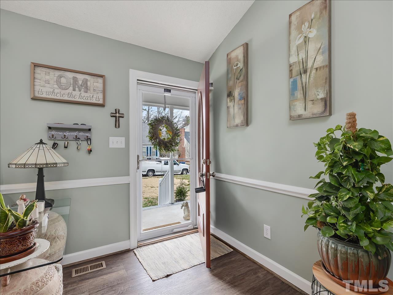 4408 Emmit Drive Raleigh, NC 27604 - Photo 14 of 38 a view of a hallway with paintings on the wall