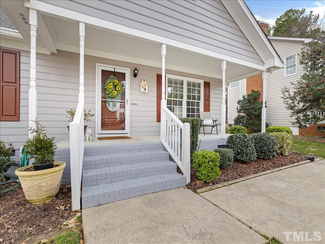4408 Emmit Drive Raleigh, NC 27604 - Photo 15 of 38 a view of a house with potted plants and a potted plant