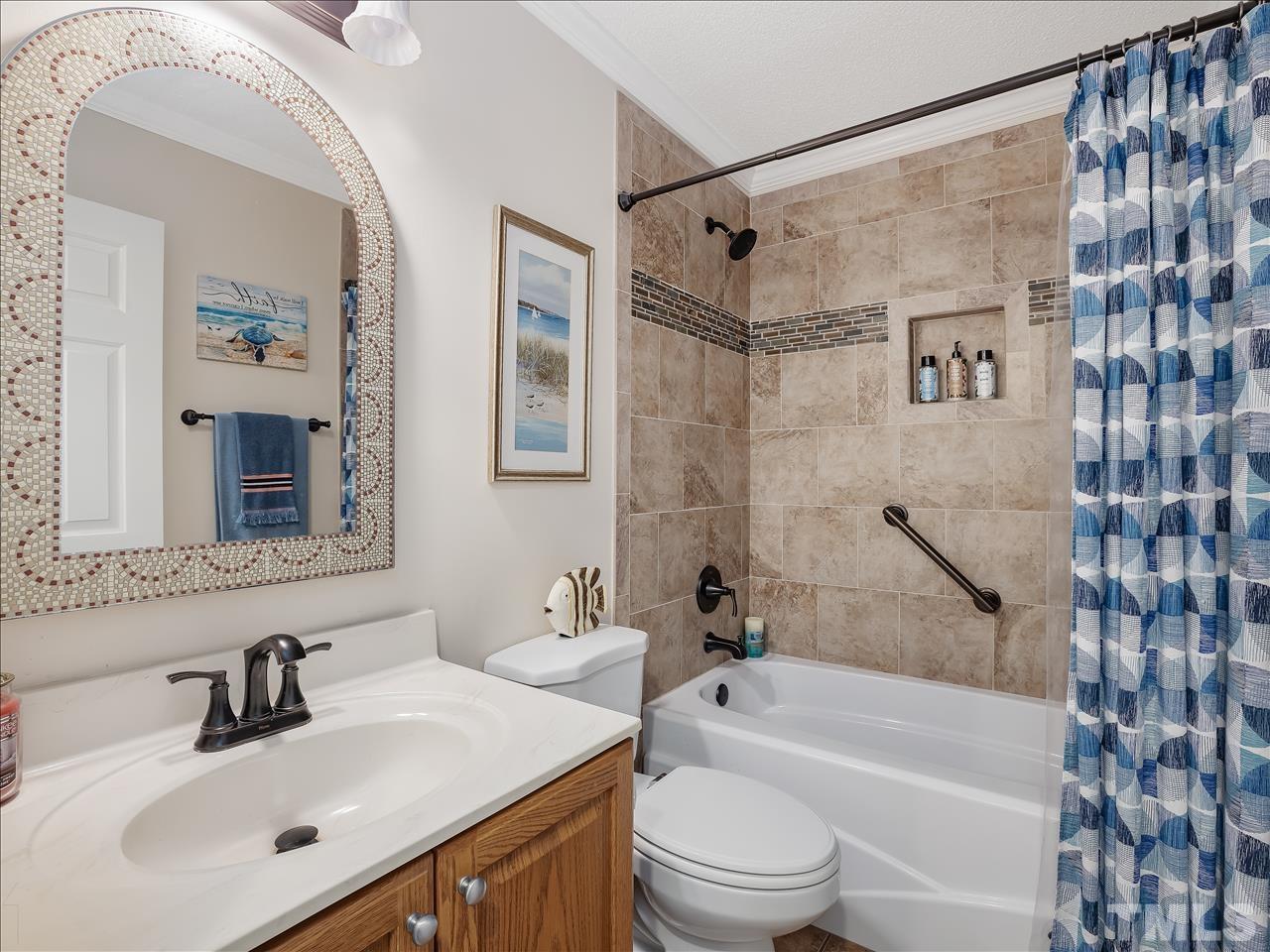 4408 Emmit Drive Raleigh, NC 27604 - Photo 3 of 38 a bathroom with a bathtub shower sink vanity mirror and toilet