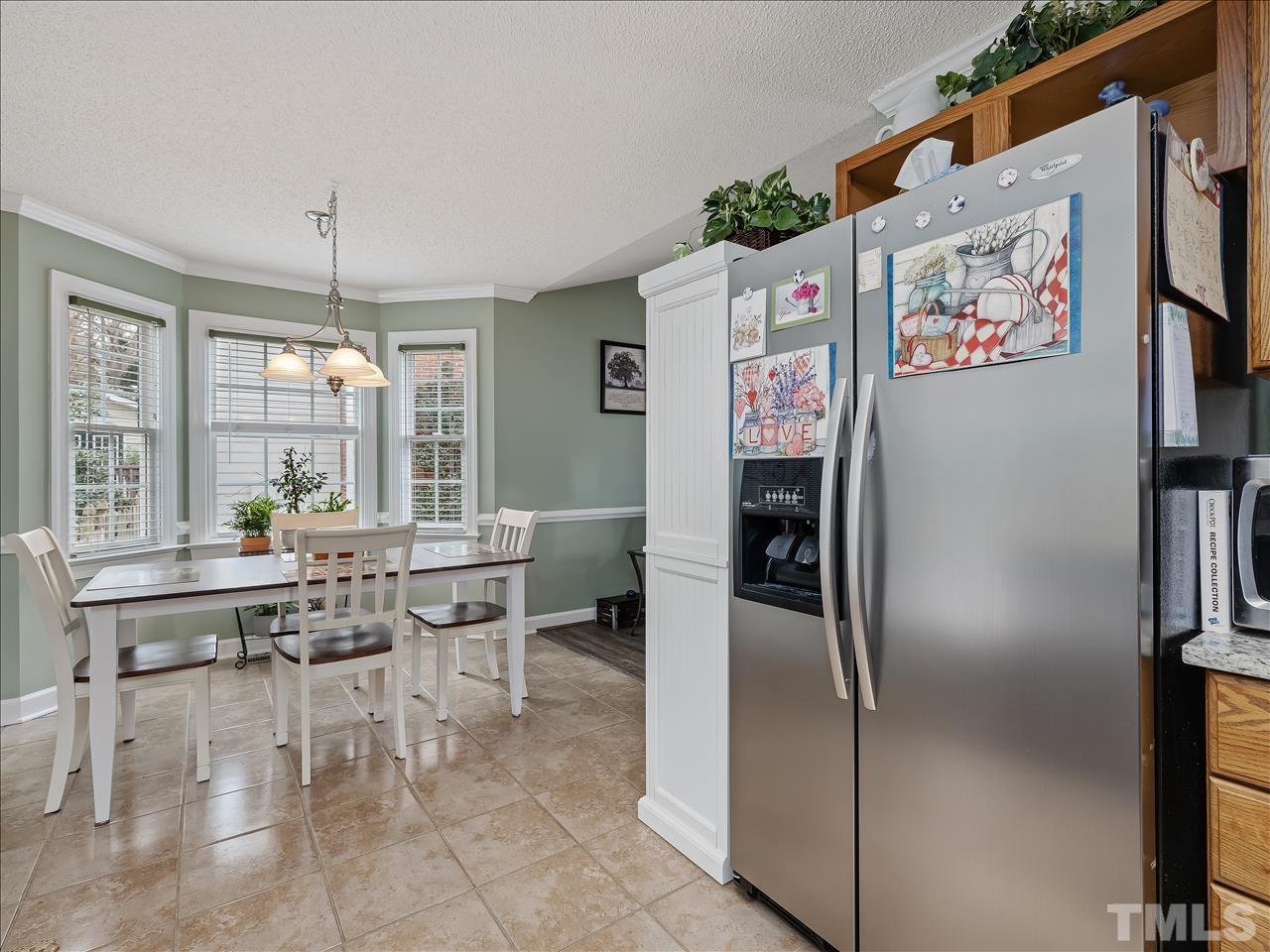 4408 Emmit Drive Raleigh, NC 27604 - Photo 35 of 38 a kitchen with stainless steel appliances granite countertop a refrigerator and a stove top oven