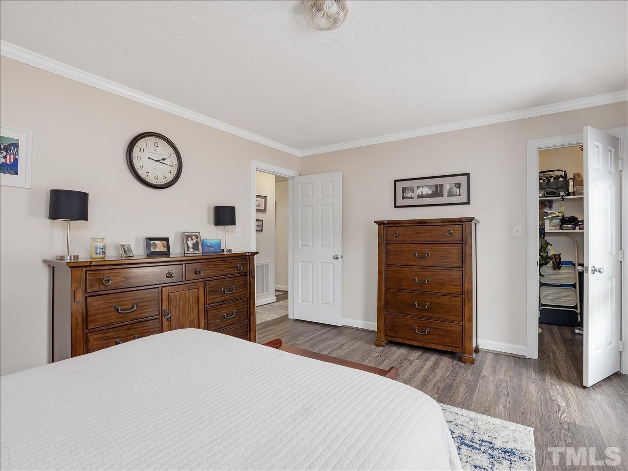 4408 Emmit Drive Raleigh, NC 27604 - Photo 4 of 38 a bedroom with a bed and a dresser
