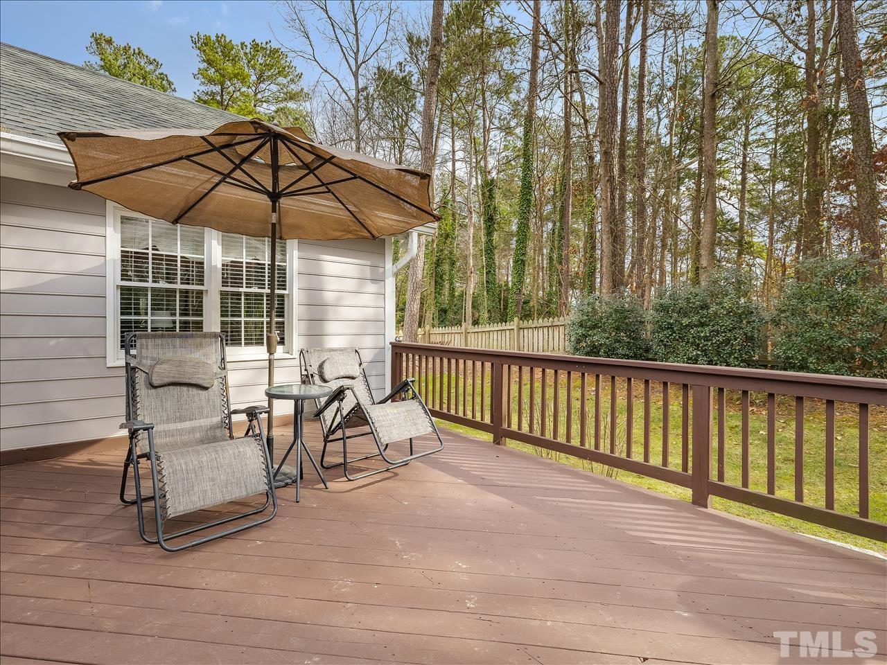 4408 Emmit Drive Raleigh, NC 27604 - Photo 8 of 38 a view of a patio with a table and chairs under an umbrella