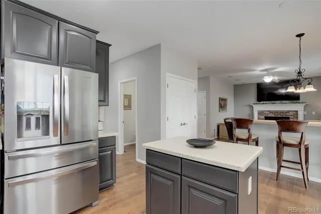 a kitchen with stainless steel appliances a refrigerator and a stove top oven