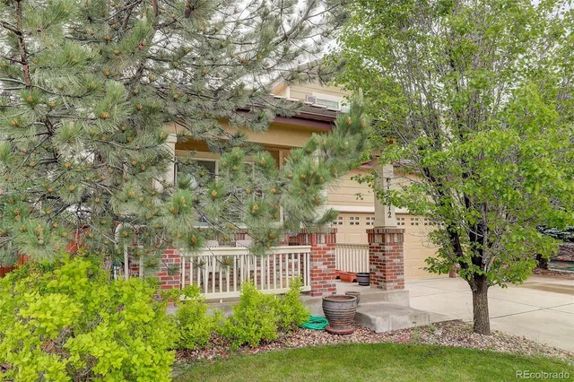 a balcony with couple of plants and trees