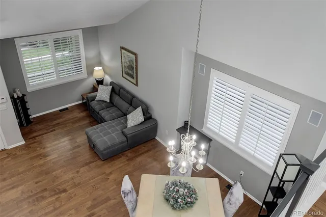 a living room with furniture chandelier and a window