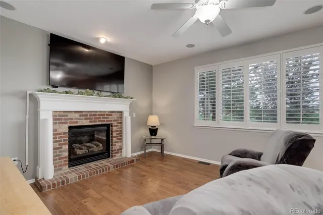 a living room with furniture fireplace and flat screen tv