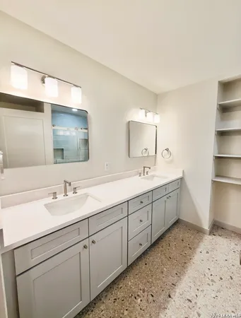 a bathroom with double sink and a mirror