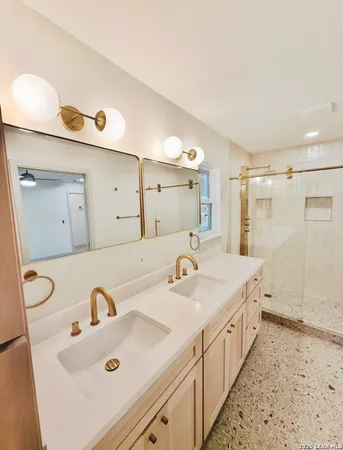a bathroom with a double vanity sink and mirror