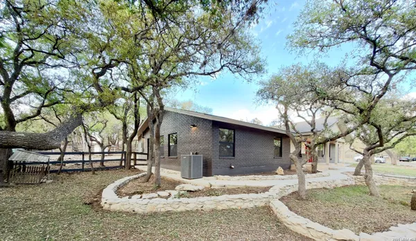 a backyard of a house with oven and outdoor seating