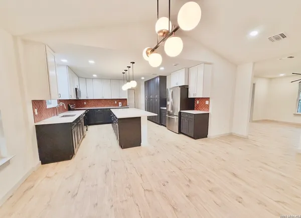 a large kitchen with lots of counter space and a sink