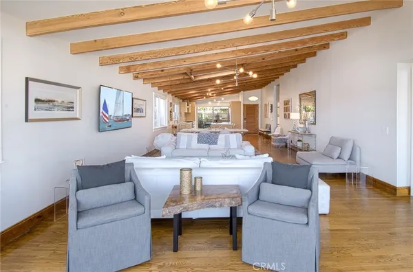a living room with furniture and a view of kitchen