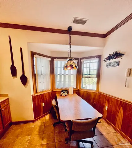 a living room with furniture kitchen and a chandelier