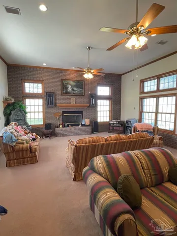 a spacious bedroom with a bed and a chandelier