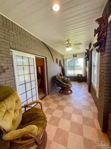 a bathroom with a toilet and a chair