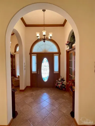 a view of a dining room with furniture and chandelier