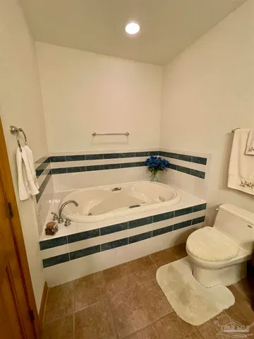 a view of a backyard with a garden and fire pit