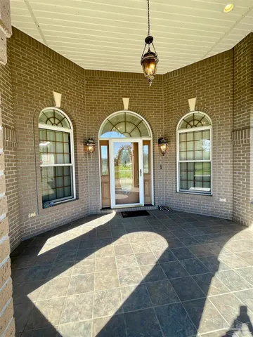 a view of a house with a yard and mountain view
