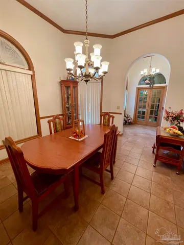 a view of a dining room with furniture and chandelier