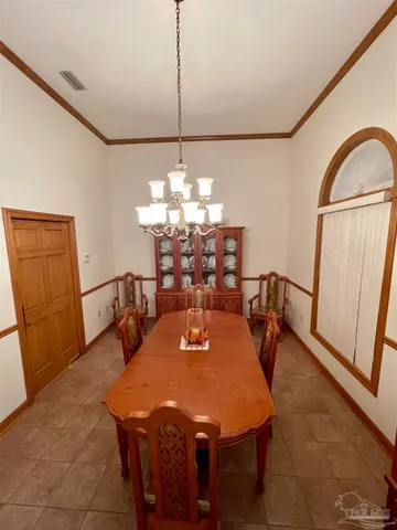 a kitchen with a refrigerator and a stove top oven