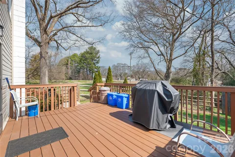 a view of a roof deck with wooden floor and fence