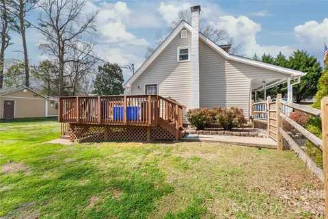 a view of a house with a yard and sitting area