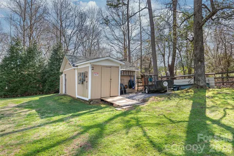 a view of a house with swimming pool and sitting area