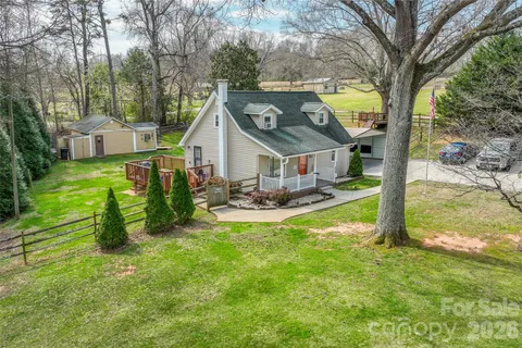 a view of a house with backyard porch and sitting area