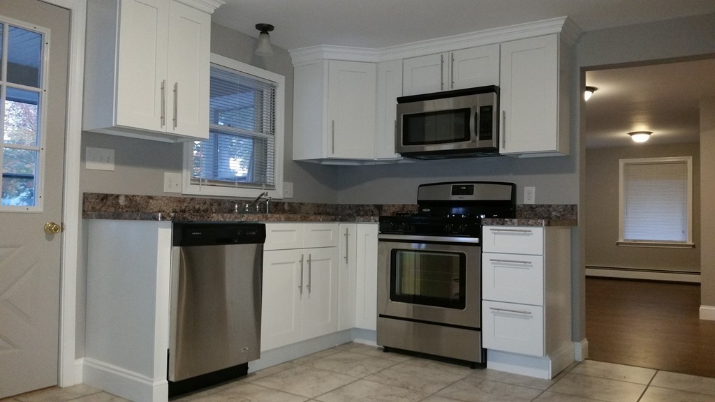 49 Drexel Street Springfield, MA 01104 - Photo 1 of 30 a kitchen with granite countertop white cabinets and stainless steel appliances
