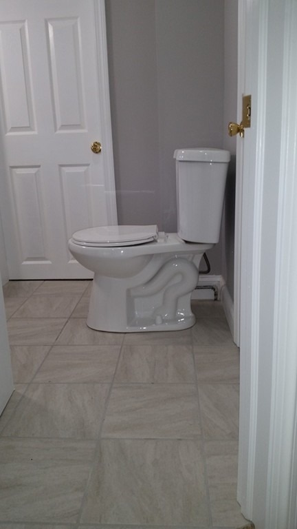 49 Drexel Street Springfield, MA 01104 - Photo 17 of 30 a white toilet sitting next to a bathroom sink
