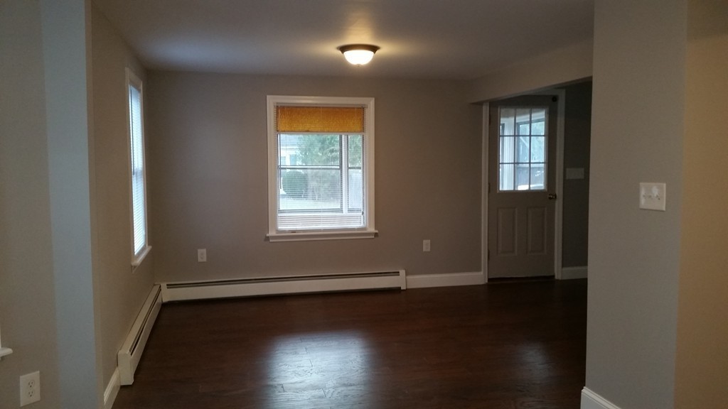 49 Drexel Street Springfield, MA 01104 - Photo 21 of 30 an empty room with wooden floor and windows
