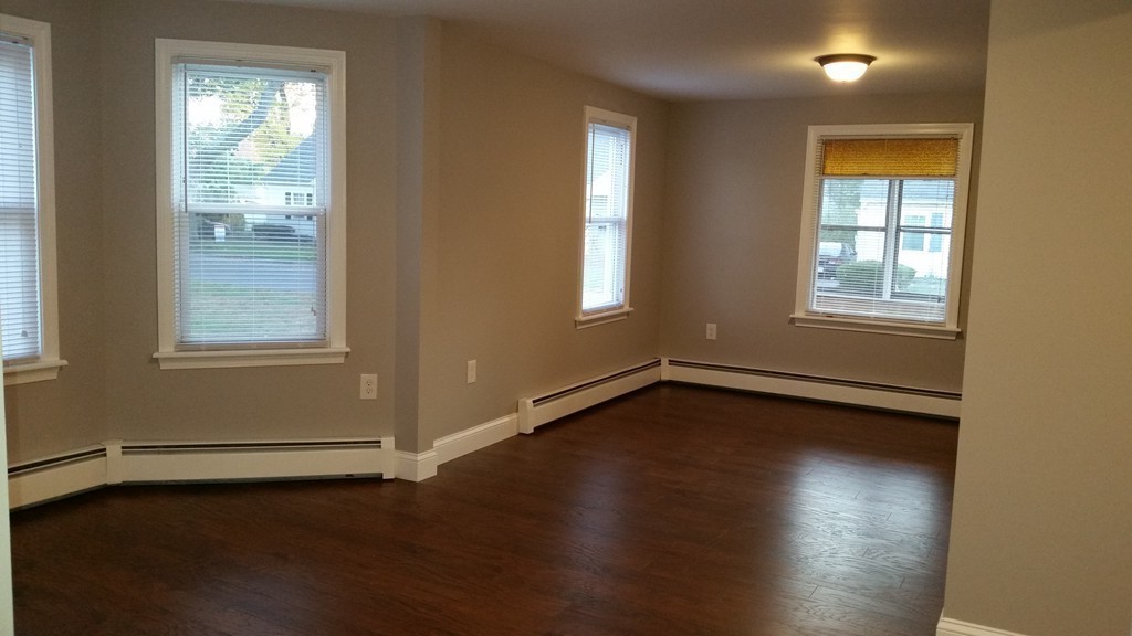 49 Drexel Street Springfield, MA 01104 - Photo 22 of 30 an empty room with wooden floor and windows