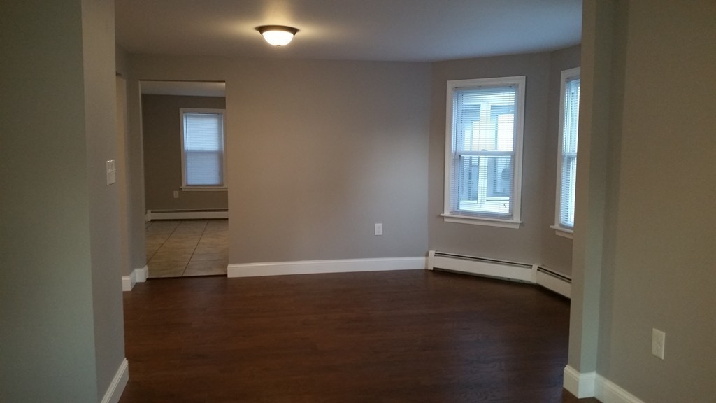 49 Drexel Street Springfield, MA 01104 - Photo 24 of 30 an empty room with wooden floor and windows