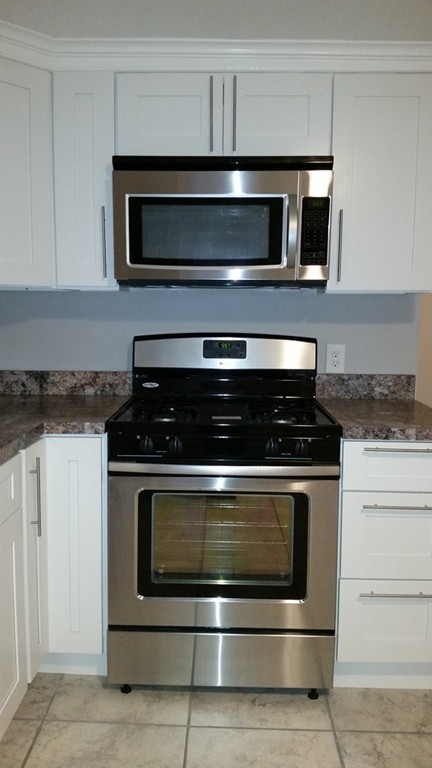 49 Drexel Street Springfield, MA 01104 - Photo 3 of 30 a stove top oven sitting inside of a kitchen