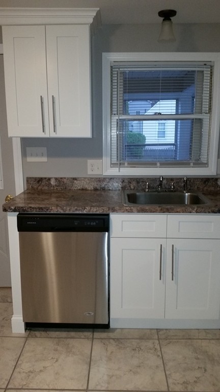 49 Drexel Street Springfield, MA 01104 - Photo 6 of 30 a kitchen with granite countertop white cabinets and sink