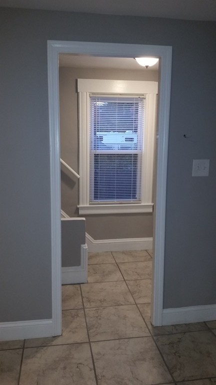 49 Drexel Street Springfield, MA 01104 - Photo 7 of 30 a view of an empty room with a fireplace