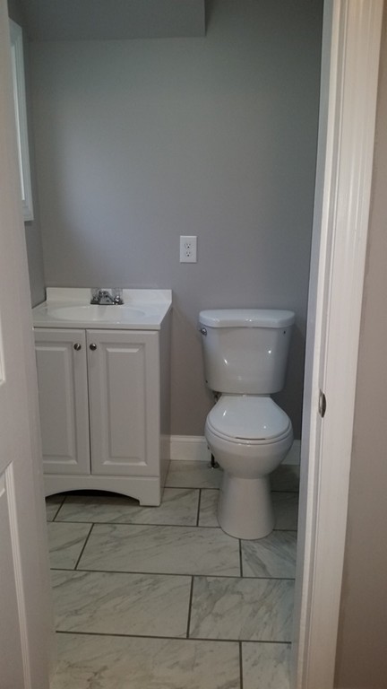 49 Drexel Street Springfield, MA 01104 - Photo 9 of 30 a white toilet sitting next to a bathroom sink