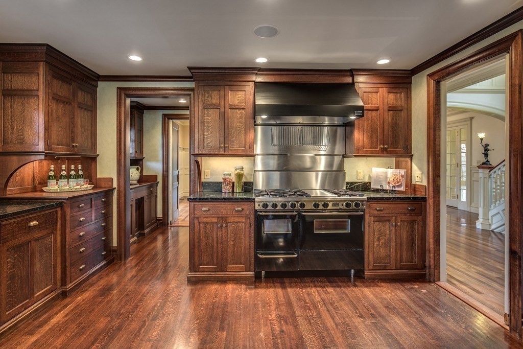 7 Percy Road Lexington, MA 02421 - Photo 16 of 29 a kitchen with stainless steel appliances granite countertop a stove and a wooden floors